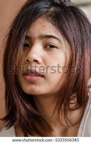 Asian girls face and Short hair with her happily smile on a sleeping time.