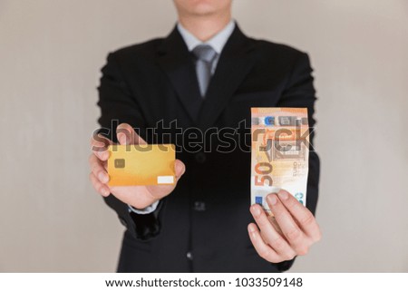 Businessman hold 50 EURO (EUR) money and credit card as business, trade, currency, investment and income concept