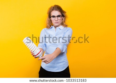 Attractive woman with energy saving bulb