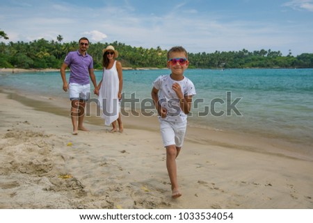 Family on vacation at the seashore of Indian ocean