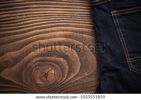 Dark jeans on wooden board with copy space