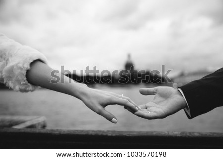 closeup of male and female handtouching holding together on blurred background for love and healing concept. Black and white photo