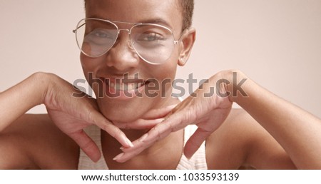 black woman with a short haircut in studio shoot closeup wearing glasses cobra