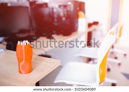 Workplace. Close-up of pencils in background series of computers in modern style.
