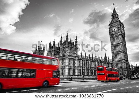 London, the UK. Red buses in motion and Big Ben, the Palace of Westminster. The icons of England in vintage, retro style. Red in black and white Royalty-Free Stock Photo #1033631770