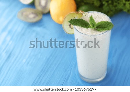 healthy food concept. milkshake in glass and fresh green vegetables. picture with soft focus