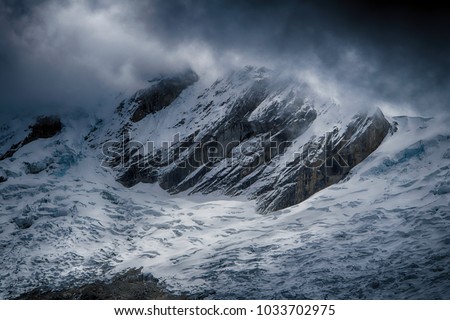 Mount Taulliraju in clouds (Peru)