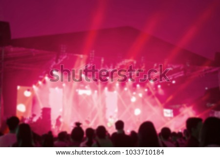 Blurred background : Bokeh lighting in outdoor concert with cheering audience, hands up