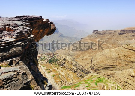 An edge of the cliff hungs over abyss 800 meter deep.  Plateau Bokur, Yemen Royalty-Free Stock Photo #1033747150