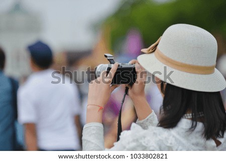 The girl is holding a camera.