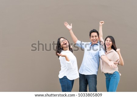 Group of happy three asian friends in casual wear standing laugh and having fun together Royalty-Free Stock Photo #1033805809