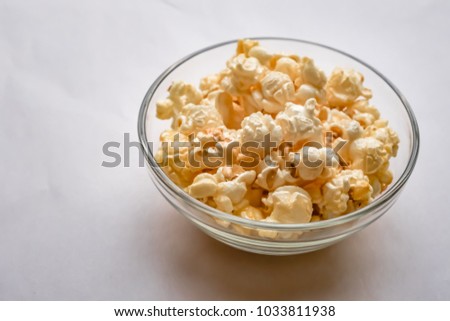 Full frame close-up bowl of popcorn. : A glass bowl filled to the brim with delicious, nutritious popcorn.