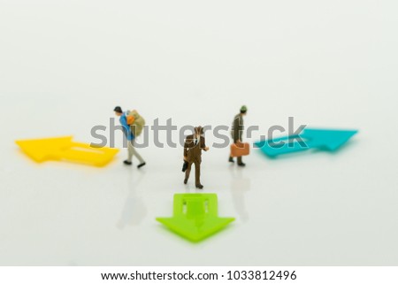 Miniature people: Business team standing on front of arrow pathway choice using as Business decision concept.