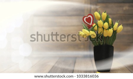  bouquet of yellow tulips in a vase on floor