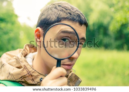 Picture of brunet biologist with magnifying glass
