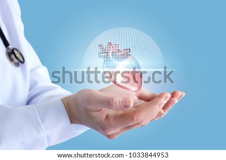 Doctor shows in the hands of a scanning of the heart on a blue background.