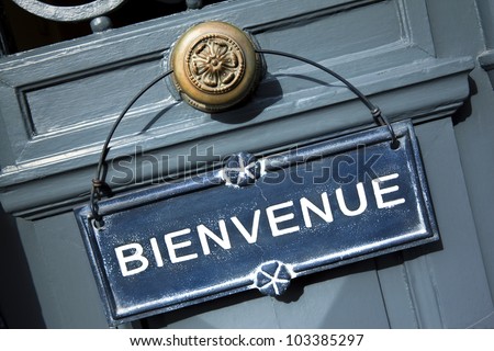 Welcome sign on a door of a French hotel