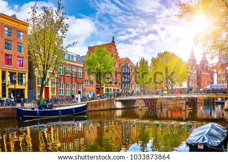 Channel in Amsterdam Netherlands houses river Amstel landmark old european city spring landscape. Royalty-Free Stock Photo #1033873864