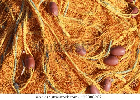 Tangled pile of fishing net with floats at a fishing harbor