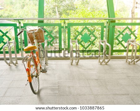 Bicycle locked to public bicycle parking rack or bike rack on pedestrian overpass