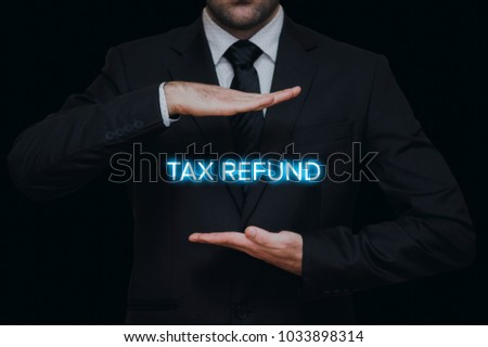 Tax refund concept. Businessman showing lighten tax refund between his hands.