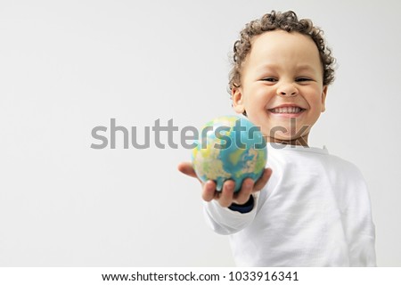 little boy with globe in his hand stock photo Royalty-Free Stock Photo #1033916341