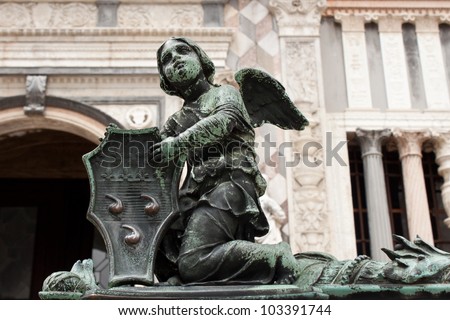 Angel holding a shield with Colleoni Coat of Arms as a decoration of the fence of Bergamo cathedral in Italy