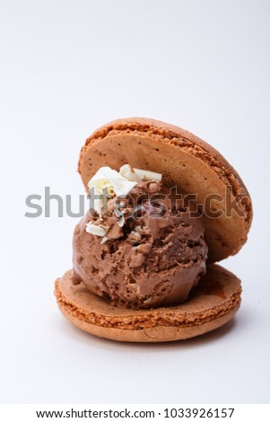 Chocolate ice cream and macaroon on plate Royalty-Free Stock Photo #1033926157