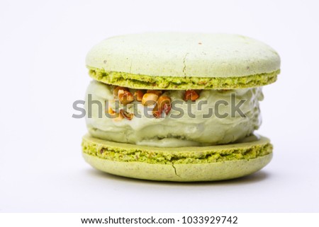 Pistachio ice cream and macaroon on white plate Royalty-Free Stock Photo #1033929742