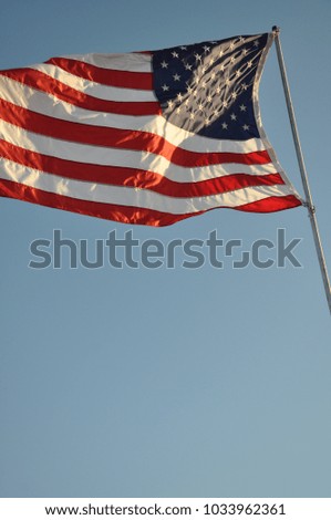 U.S. flag on pole and blue sky