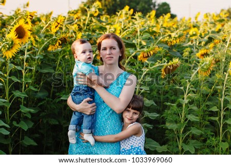 family in the field of sunflowers enjoy life