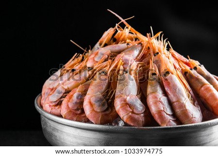 cooked Shrimps in a metal bucket on a dark background