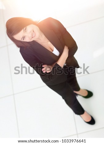 photo in full growth, successful business woman looking at camer