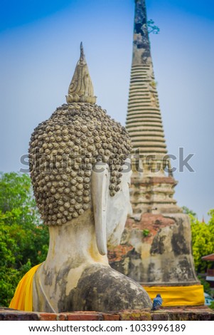 Close up of selective focus of the head of ancient Buddha Statue at WAT YAI CHAI MONGKOL, The Historic City of Ayutthaya, Thailand, in a blurred background