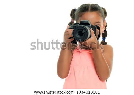 Cute multiracial small girl taking pictures with a professional camera - Isolated on a white background