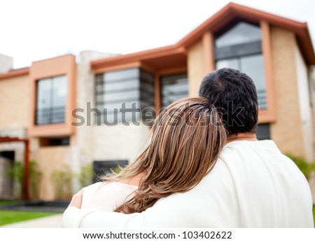 Loving couple looking at their dream house Royalty-Free Stock Photo #103402622