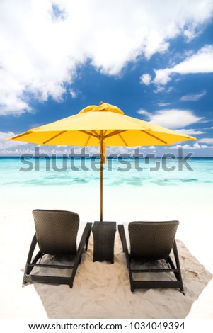 Sun umbrella and beach beds on tropical sandy beach, Tropical destinations Royalty-Free Stock Photo #1034049394