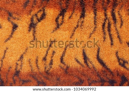 Pattern of tiger fur fabric texture for background.