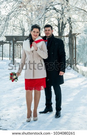 
snow on the wedding day and beautiful young people