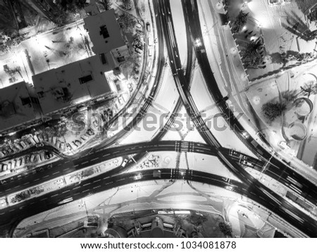 Night aerial view of three way intersection covered in snow