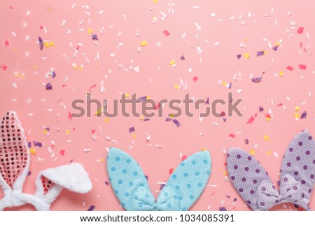 Top view aerial image shot of arrangement decoration Happy Easter holiday & fashion background concept.Flat lay colorful bunny ears on modern rustic pink paper at home office desk.space for mock up