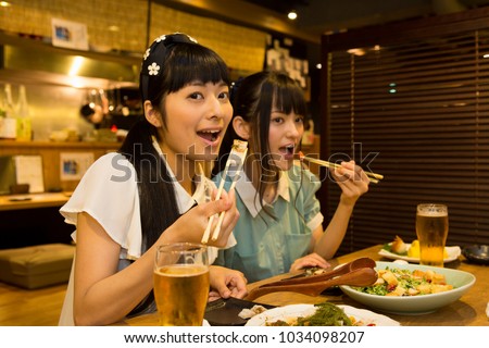 Japanese young people who enjoy a drinking party Royalty-Free Stock Photo #1034098207
