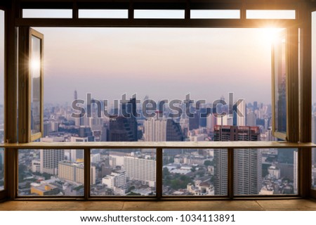 Beautiful Blank coffee shop or (cafe,restaurant) against blurred bangkok city view background, For montage product display or design key visual layout,  at sunrise.