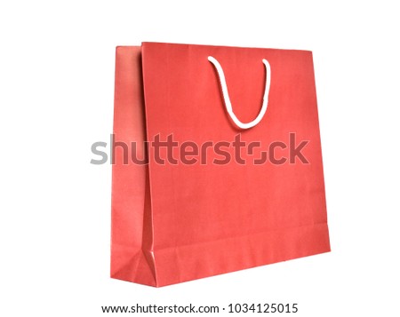 Red paper shopping bag with handle made by white rope isolated on white background.