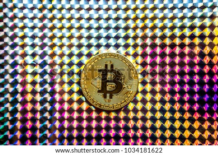 Cryptocurrency coin , Gold Bitcoin coin on holographic foil background