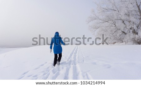 young girl walking through the snow, trees in the frost, frosty morning, winter, winter road, fog over the river