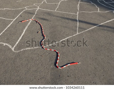 Jump rope on decorated playground asphalt