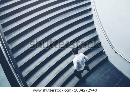 Businessman running fast upstairs Growth up Success concept Royalty-Free Stock Photo #1034272948