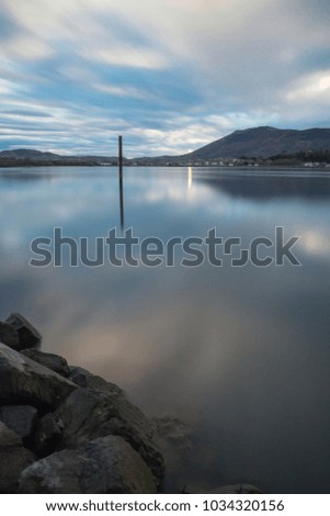 scenic view on boat pole in atlantic ocean in long exposure with mountain jaizkibel in the back, basque country, france