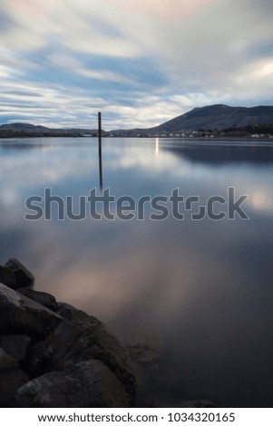 scenic view on boat pole in atlantic ocean in long exposure with mountain jaizkibel in the back, basque country, france
